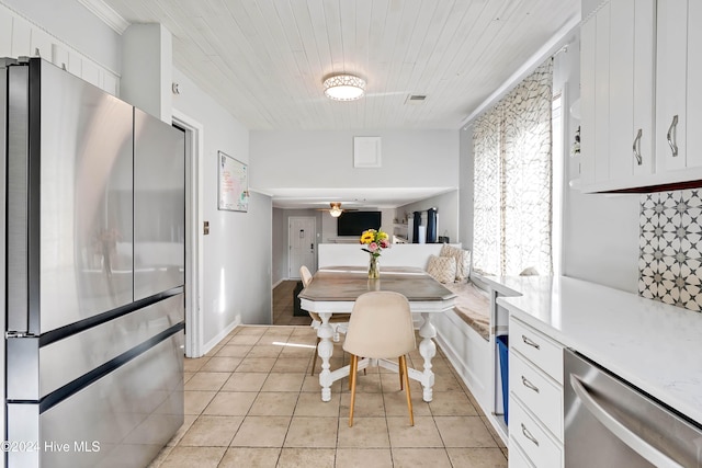 tiled dining room with ceiling fan