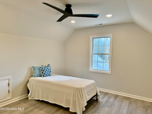 bedroom with ceiling fan, hardwood / wood-style floors, and lofted ceiling