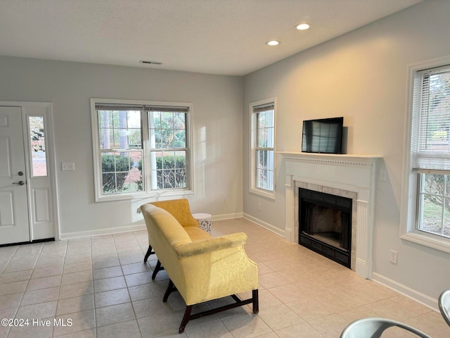 tiled living room with a fireplace