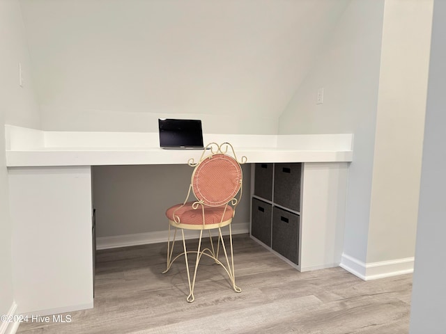 office with hardwood / wood-style floors and lofted ceiling