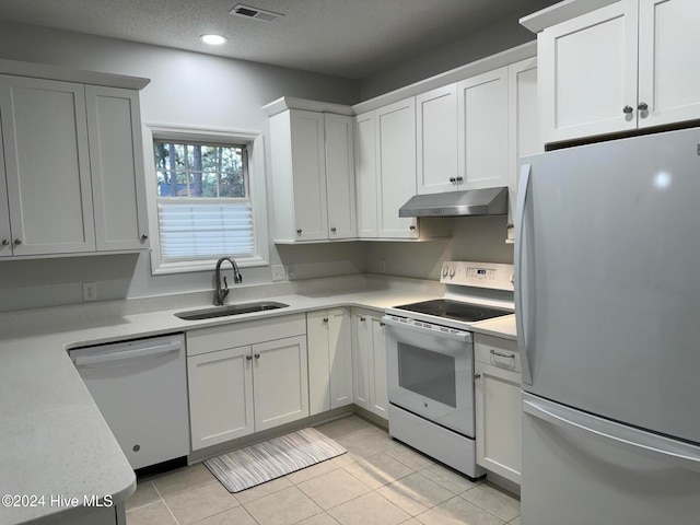 kitchen with white cabinetry, dishwasher, sink, white range with electric stovetop, and refrigerator