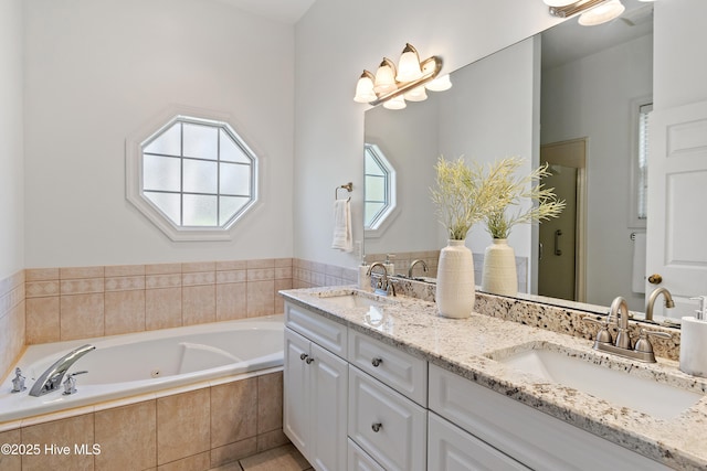 bathroom with a jetted tub, a stall shower, double vanity, and a sink