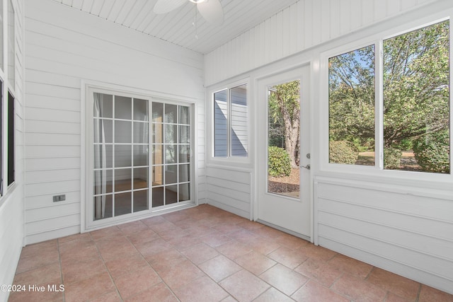 unfurnished sunroom with a ceiling fan