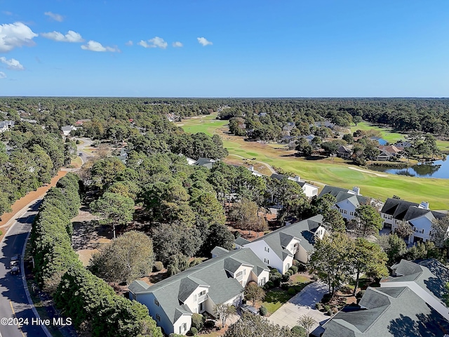 birds eye view of property with view of golf course, a water view, a wooded view, and a residential view