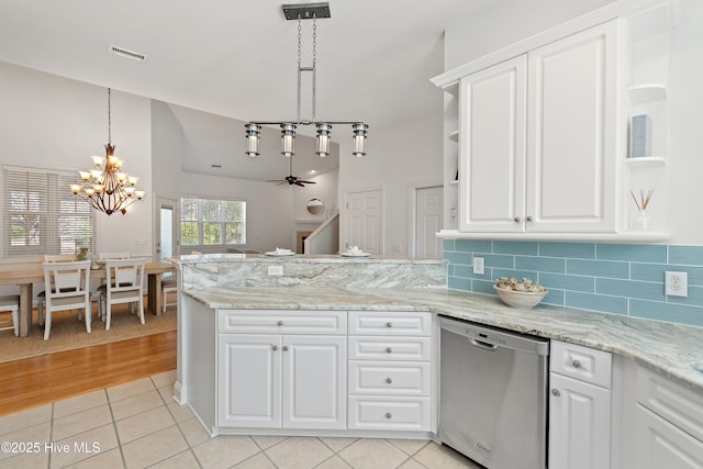 kitchen featuring light tile patterned floors, visible vents, a peninsula, open shelves, and stainless steel dishwasher