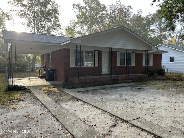 view of front facade featuring a porch and a carport