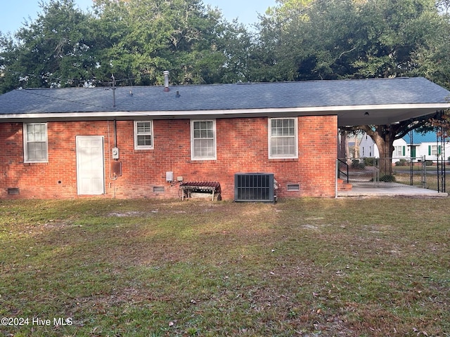 back of house with a yard, cooling unit, and a patio