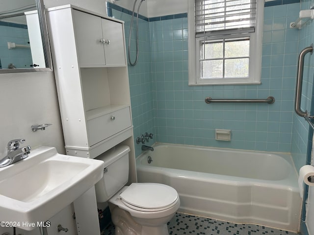 full bathroom featuring tiled shower / bath, sink, and toilet