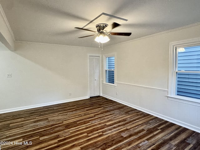 spare room featuring a textured ceiling, dark hardwood / wood-style flooring, ceiling fan, and ornamental molding