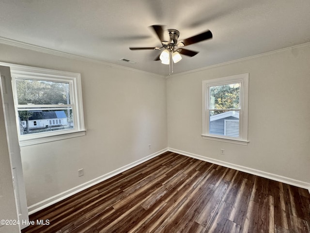 empty room with dark hardwood / wood-style floors, ceiling fan, and crown molding