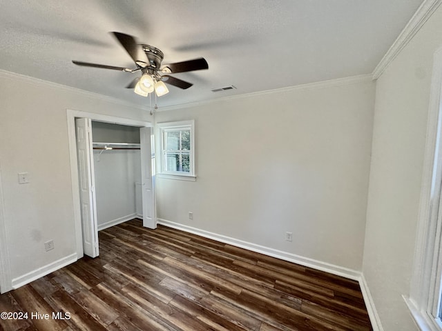 unfurnished bedroom with ornamental molding, a textured ceiling, ceiling fan, dark hardwood / wood-style floors, and a closet