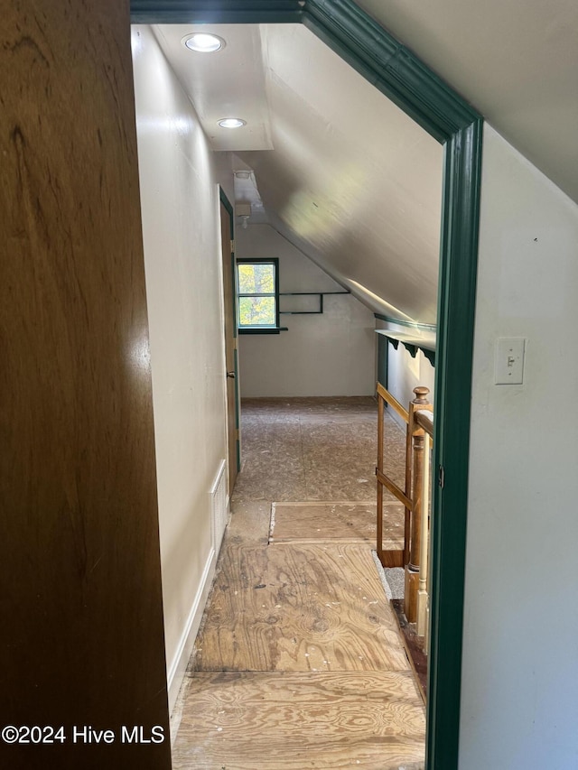 hall featuring lofted ceiling