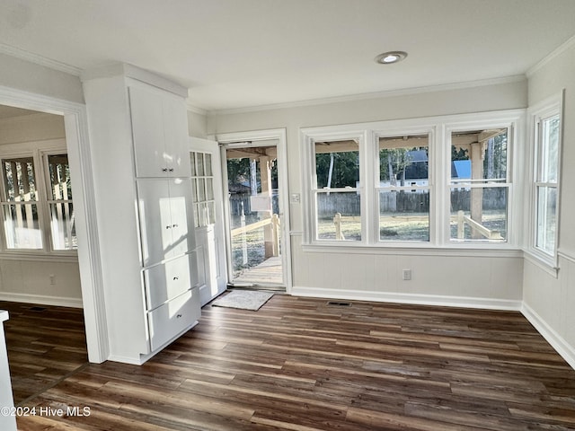 doorway to outside featuring crown molding and dark wood-type flooring