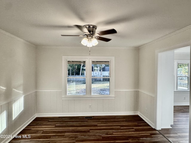 empty room with dark hardwood / wood-style flooring, ceiling fan, and ornamental molding