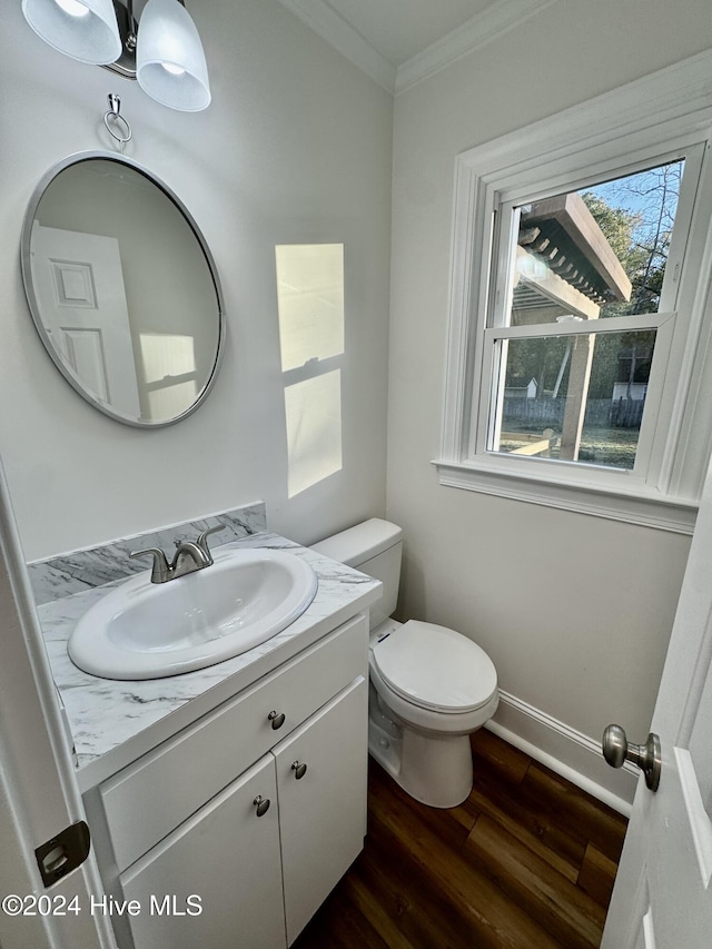 bathroom featuring crown molding, toilet, vanity, and hardwood / wood-style flooring