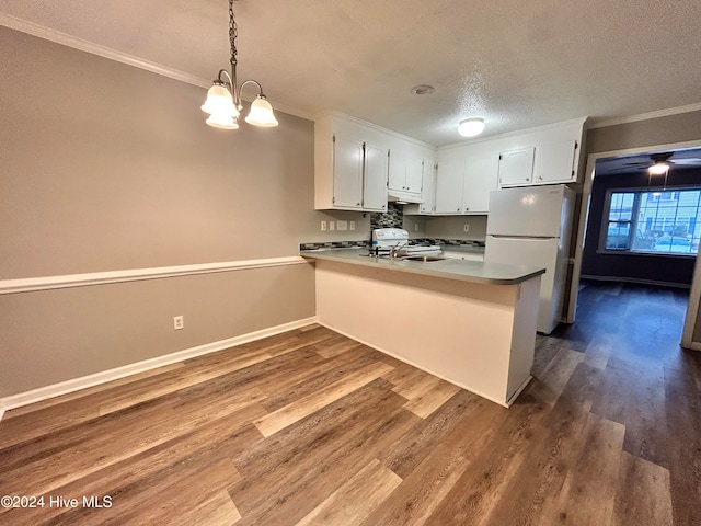 kitchen featuring kitchen peninsula, hardwood / wood-style flooring, pendant lighting, and white refrigerator