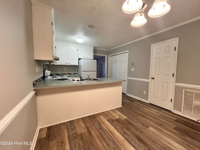 kitchen with kitchen peninsula, white cabinetry, white fridge, and dark hardwood / wood-style flooring