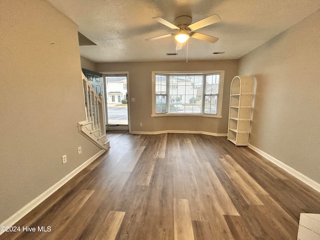 unfurnished room featuring ceiling fan, wood-type flooring, and a textured ceiling