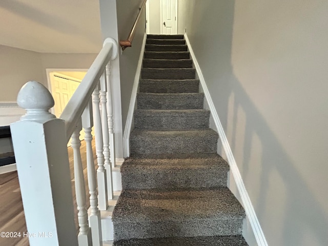 stairs with hardwood / wood-style floors