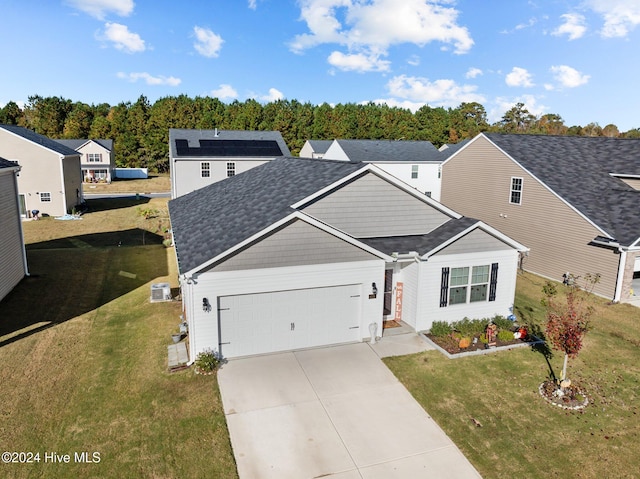 view of front facade with a front yard and a garage