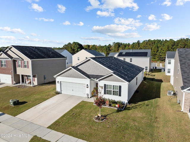 view of front facade with a front yard and a garage