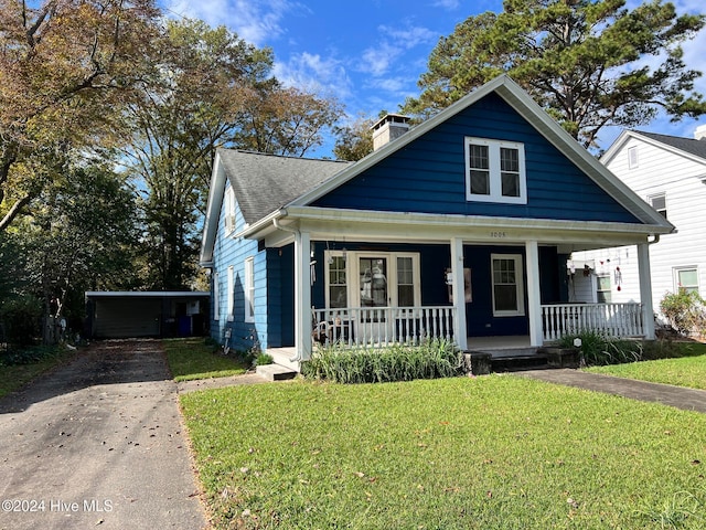 bungalow-style house with covered porch and a front yard