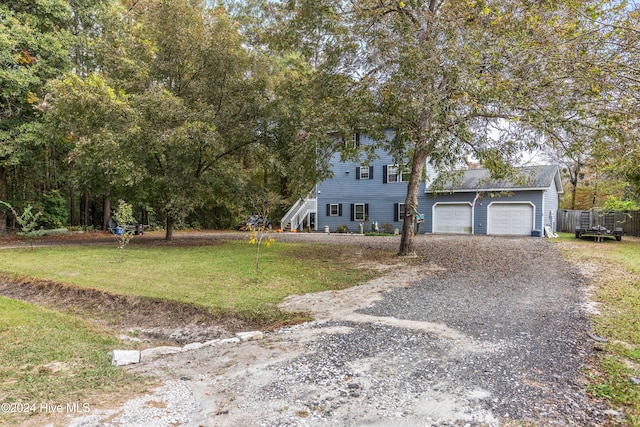 view of front of home with a front lawn and a garage