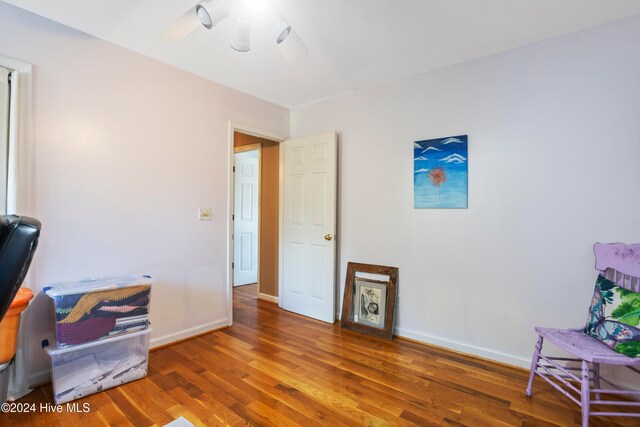 interior space featuring ceiling fan and dark hardwood / wood-style flooring