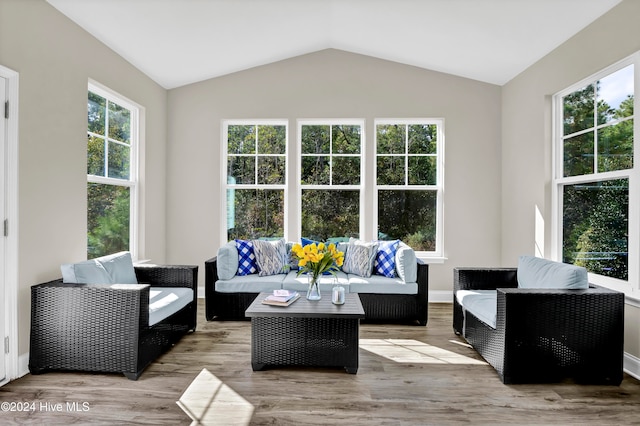 sunroom / solarium featuring vaulted ceiling