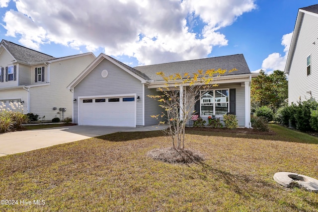 view of front of home with a front yard and a garage