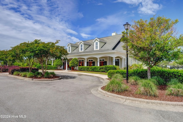 new england style home featuring covered porch