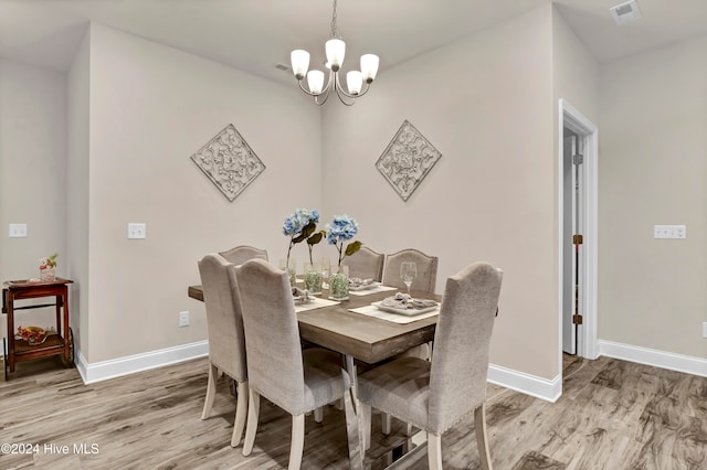 dining space with a chandelier and hardwood / wood-style floors