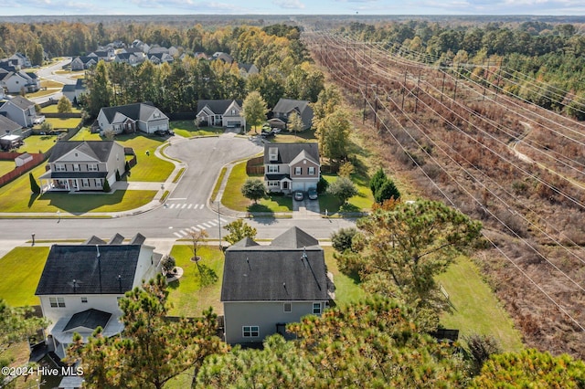 aerial view featuring a forest view and a residential view