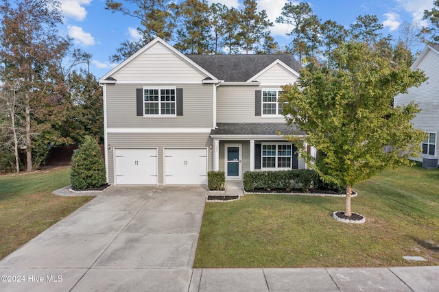 traditional-style house featuring concrete driveway, a front lawn, a shingled roof, and a garage