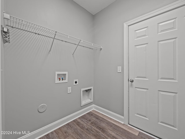 laundry room with laundry area, hookup for an electric dryer, dark wood finished floors, washer hookup, and baseboards
