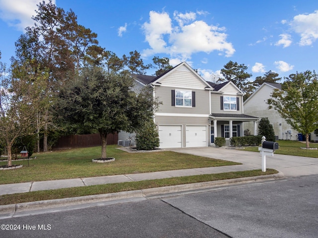 view of front of house with an attached garage, fence, concrete driveway, central air condition unit, and a front yard