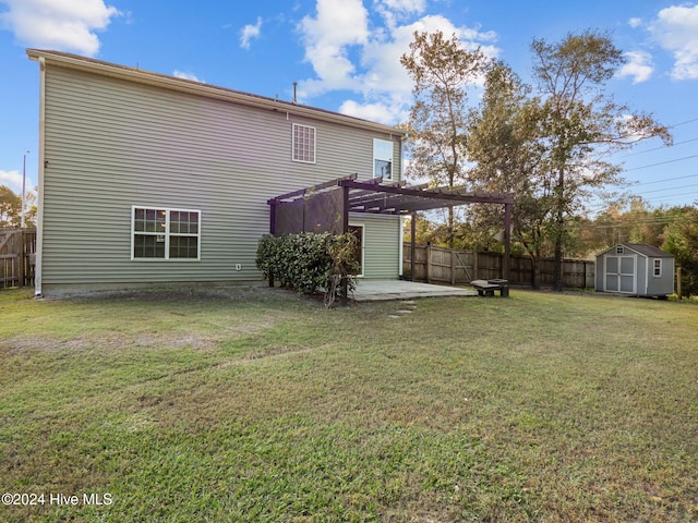 back of property featuring a pergola, a patio, a lawn, and a shed