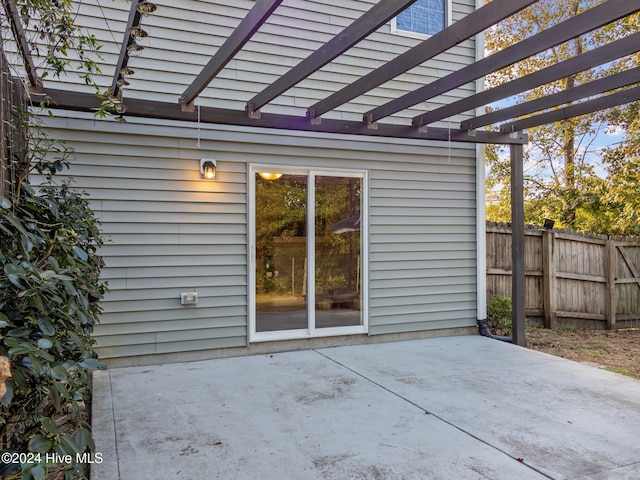 view of patio with a pergola and fence