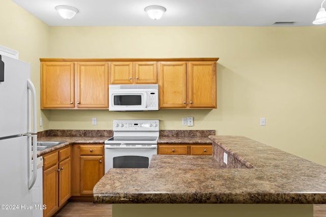 kitchen featuring white appliances and wood-type flooring