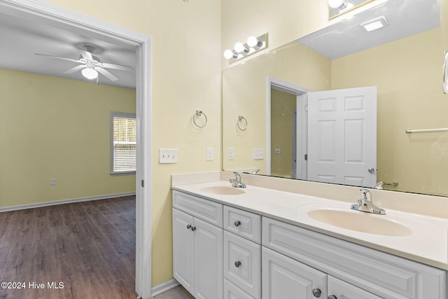 bathroom with hardwood / wood-style flooring, ceiling fan, and vanity