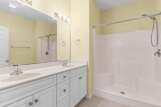 bathroom featuring tile patterned flooring, vanity, and walk in shower