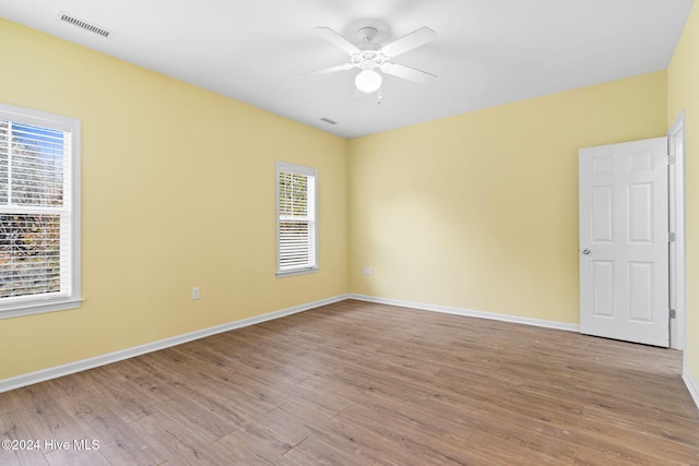 spare room with light hardwood / wood-style flooring and ceiling fan