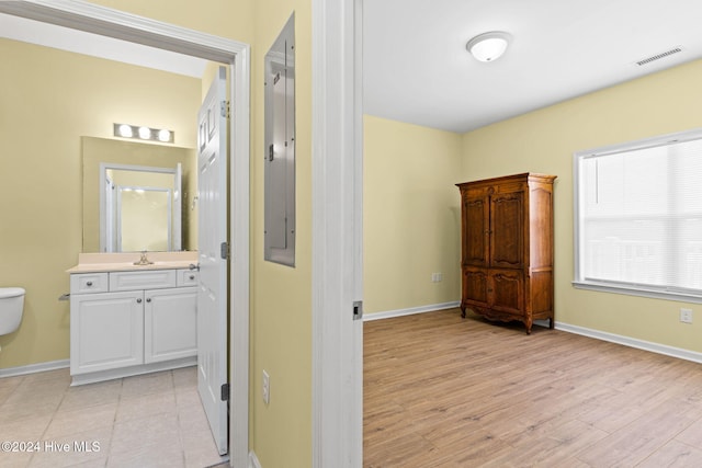 hallway with sink and light hardwood / wood-style floors