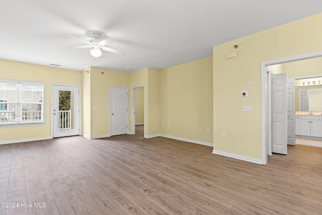 unfurnished living room featuring ceiling fan and light hardwood / wood-style flooring