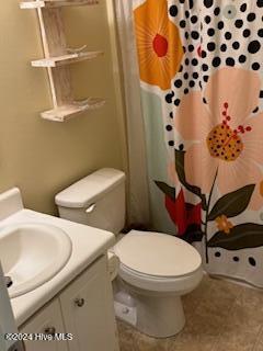 bathroom with vanity, toilet, and a shower with shower curtain