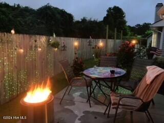 patio terrace at dusk with a fire pit