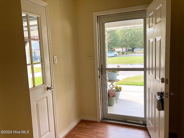 doorway to outside with light wood-type flooring