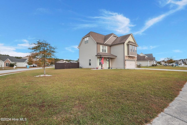 view of front of property featuring a front yard and a garage