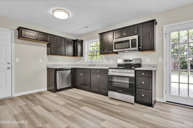 1912 Paulette Rd, Morehead City, NC 28557 - kitchen featuring stainless steel appliances, light wood-type flooring, plenty of natural light, and a sink