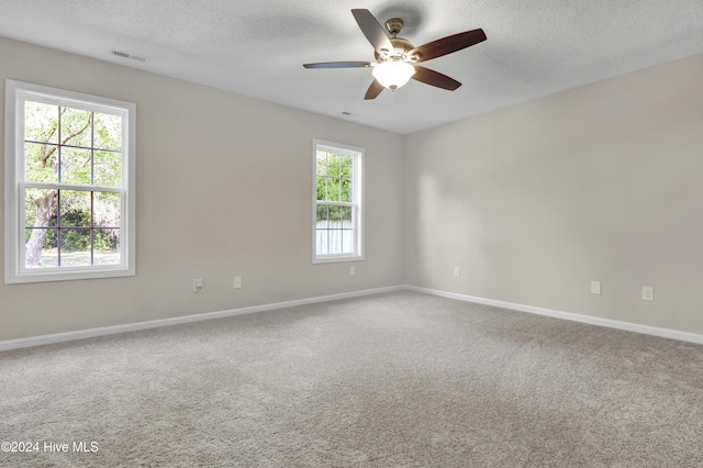 1912 Paulette Rd, Morehead City, NC 28557 - carpeted spare room with a textured ceiling, ceiling fan, and baseboards
